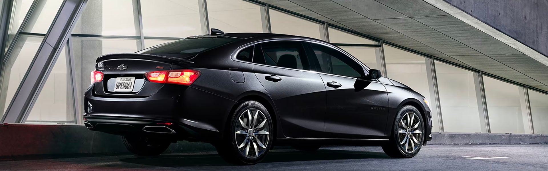 Black 2025 Chevrolet Malibu parked under a bridge