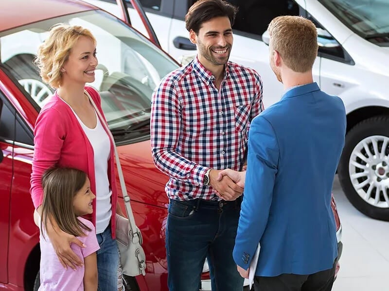 Family in showroom to shop car contacting with sales person
